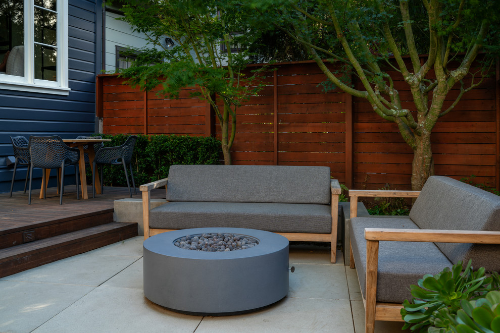 Inspiration for a small modern backyard patio in San Francisco with a fire feature and concrete pavers.