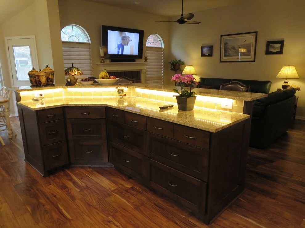 Large transitional medium tone wood floor and brown floor eat-in kitchen photo in Austin with an undermount sink, shaker cabinets, dark wood cabinets, granite countertops, multicolored backsplash, ceramic backsplash, stainless steel appliances and an island