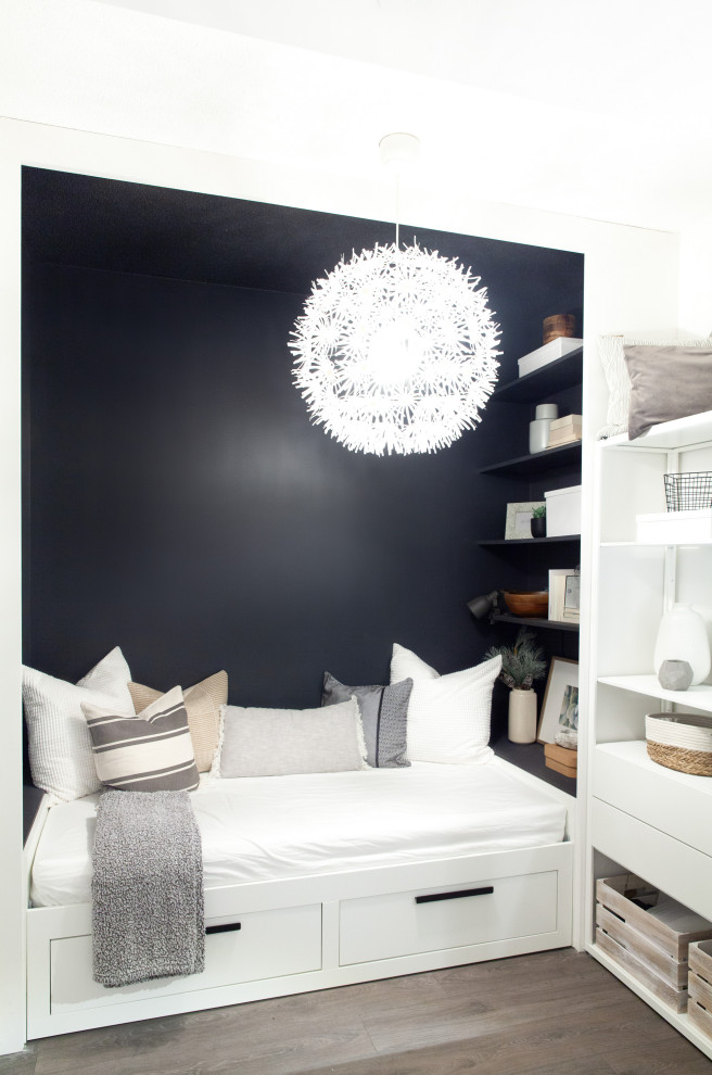 This is an example of a small scandinavian guest bedroom in Toronto with black walls.