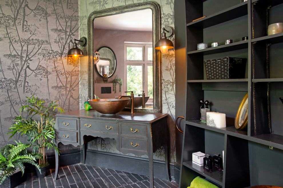 Inspiration for a bohemian bathroom in London with flat-panel cabinets, black cabinets, grey walls, a vessel sink, wooden worktops, black floors, brown worktops, a single sink, a freestanding vanity unit and wallpapered walls.