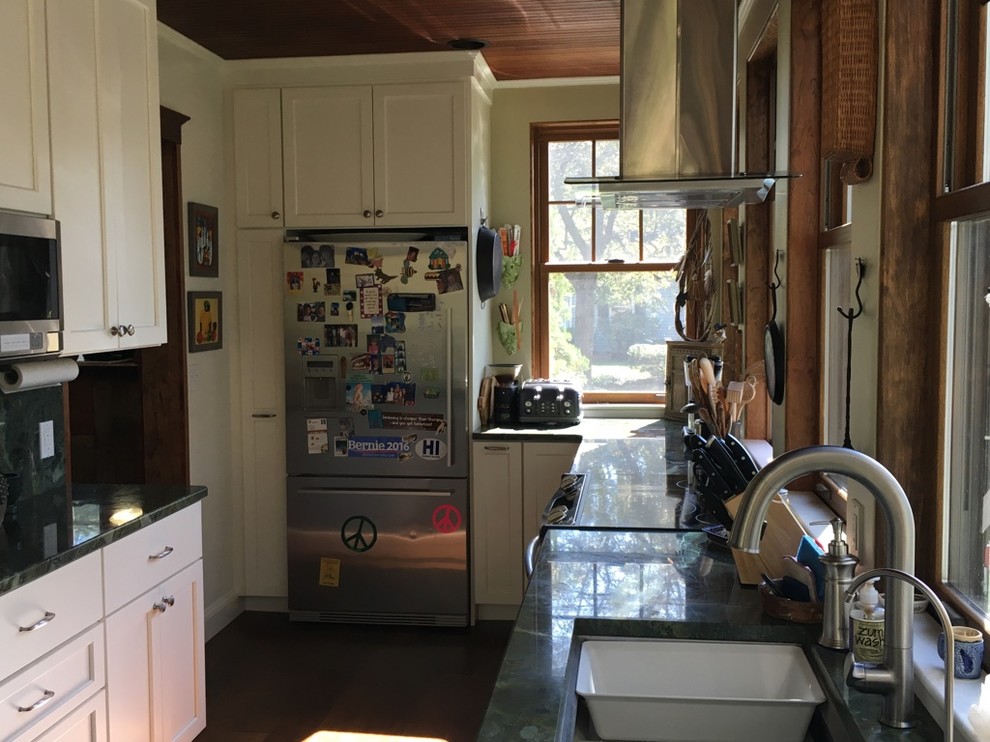 Transitional u-shaped dark wood floor kitchen photo in Boston with an undermount sink, shaker cabinets, white cabinets, granite countertops and stainless steel appliances