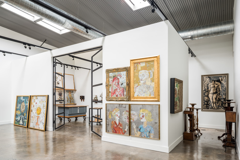 Large industrial home studio in Houston with white walls and concrete floors.