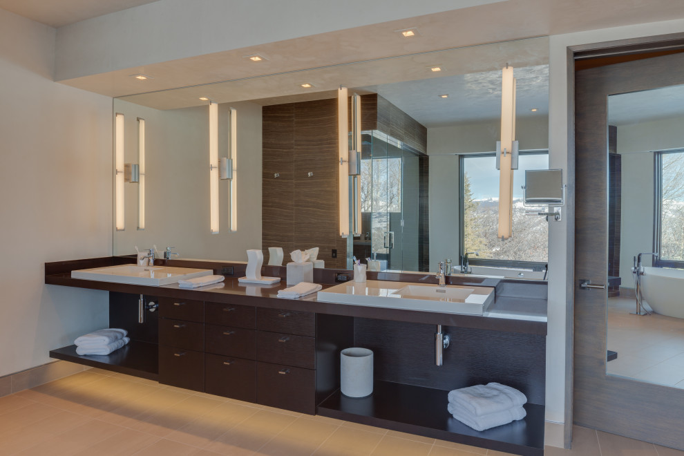 Large contemporary master bathroom in Denver with flat-panel cabinets, brown cabinets, a freestanding tub, a double shower, white walls, porcelain floors, a vessel sink, engineered quartz benchtops, grey floor, a hinged shower door, brown benchtops, a double vanity and a built-in vanity.