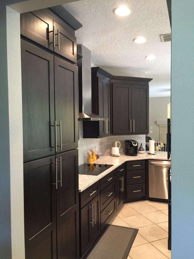 Design ideas for a small transitional l-shaped eat-in kitchen in Orlando with an undermount sink, shaker cabinets, brown cabinets, quartzite benchtops, grey splashback, marble splashback, stainless steel appliances, porcelain floors, with island, beige floor and grey benchtop.
