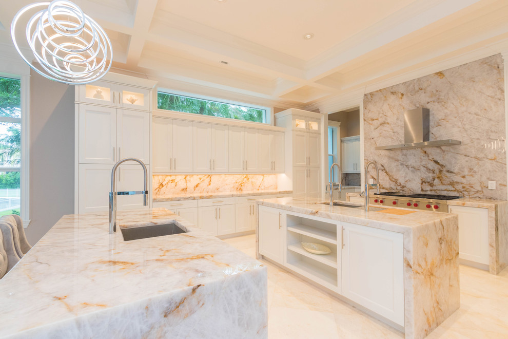 Open concept kitchen - huge transitional u-shaped marble floor and white floor open concept kitchen idea with an undermount sink, flat-panel cabinets, white cabinets, quartzite countertops, white backsplash, stone slab backsplash and two islands