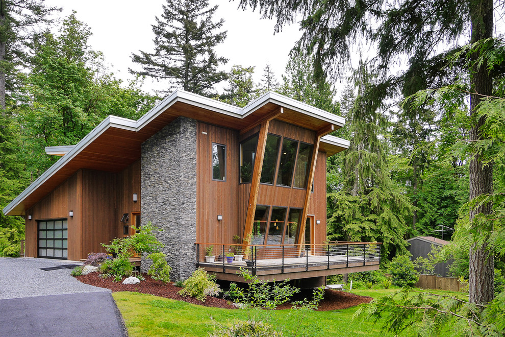 Photo of a contemporary two-storey exterior in Seattle with wood siding.