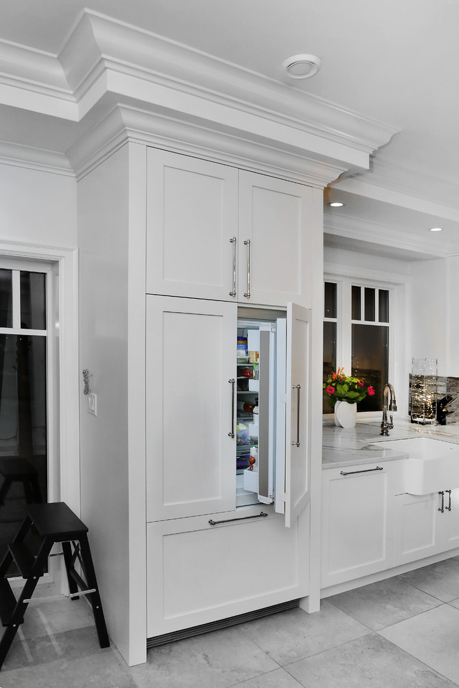 Inspiration for a large transitional l-shaped ceramic tile and gray floor eat-in kitchen remodel in Vancouver with a farmhouse sink, white cabinets, multicolored backsplash, ceramic backsplash, an island, shaker cabinets, quartzite countertops, paneled appliances and gray countertops