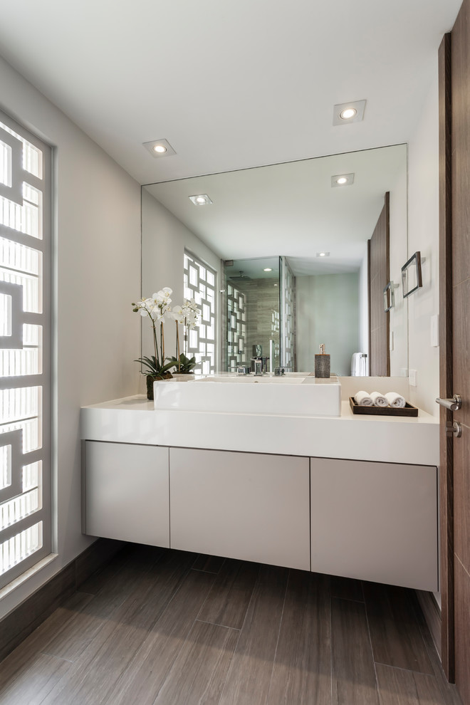 Design ideas for a contemporary bathroom in Boston with flat-panel cabinets, grey cabinets, white walls and a vessel sink.