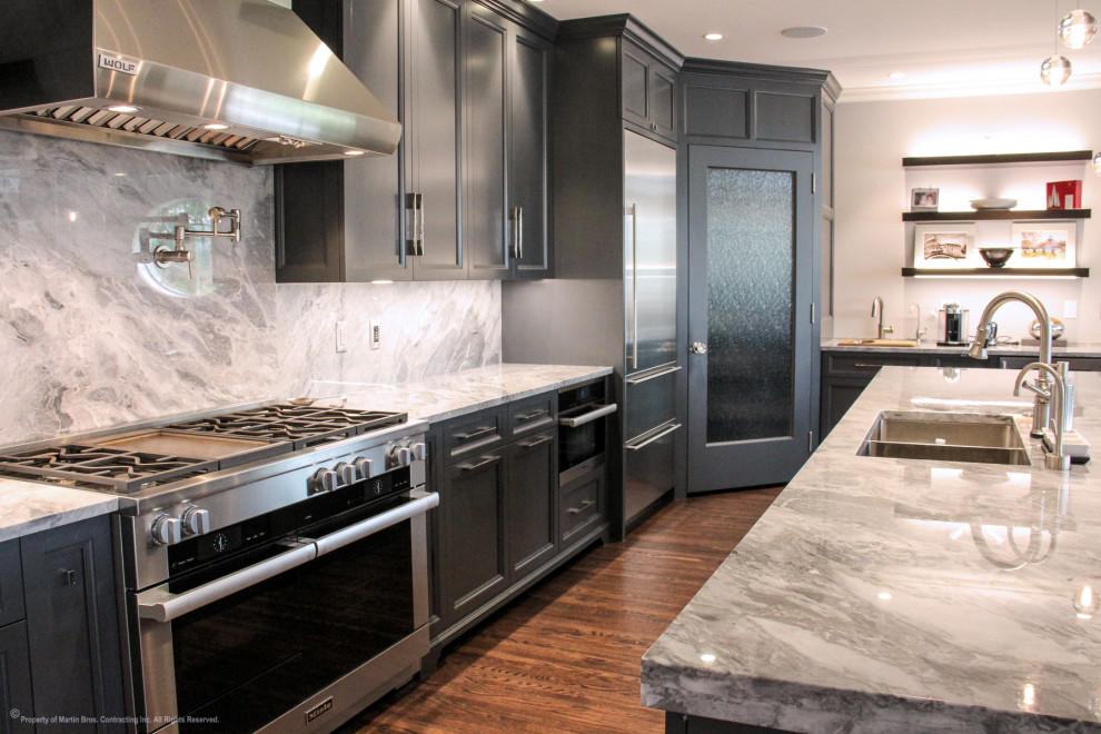 Inspiration for a large transitional single-wall medium tone wood floor open concept kitchen remodel with a double-bowl sink, recessed-panel cabinets, gray cabinets, marble countertops, multicolored backsplash, stainless steel appliances, an island and marble backsplash