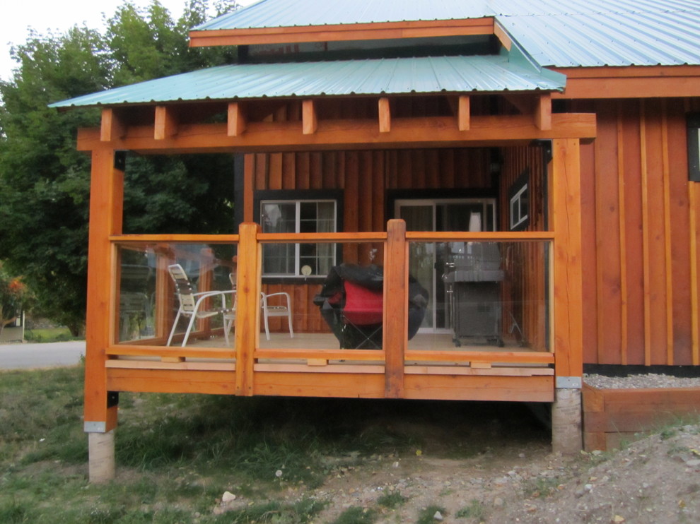 Inspiration for a mid-sized rustic side yard balcony deck remodel in Vancouver with a roof extension