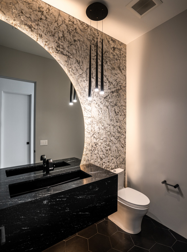 Inspiration for a small modern cloakroom in Phoenix with black cabinets, a one-piece toilet, limestone tiles, porcelain flooring, a submerged sink, marble worktops, black floors, black worktops and a floating vanity unit.
