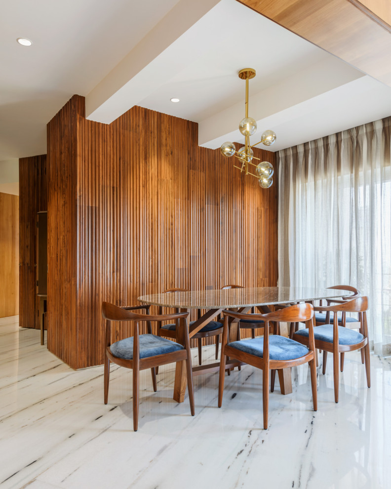 Inspiration for a contemporary open plan dining in Mumbai with brown walls, no fireplace, multi-coloured floor and wood walls.