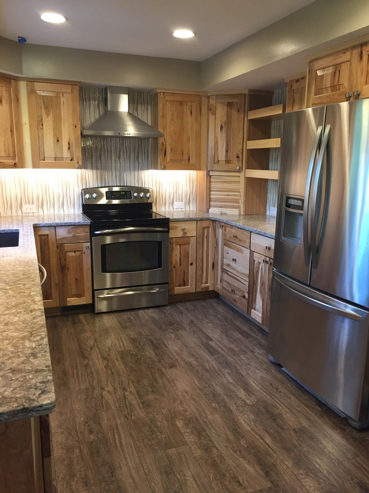 Inspiration for a mid-sized rustic u-shaped laminate floor and brown floor eat-in kitchen remodel in Omaha with an undermount sink, raised-panel cabinets, light wood cabinets, quartz countertops, beige backsplash, porcelain backsplash, stainless steel appliances, an island and gray countertops