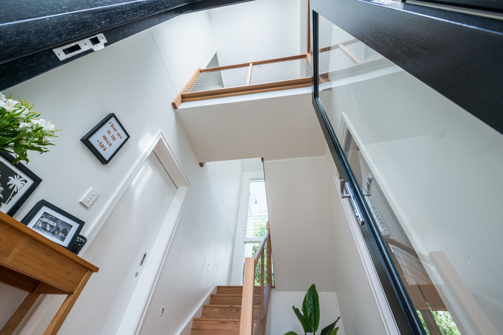 Photo of a small contemporary wood u-shaped staircase in Brisbane with wood risers.