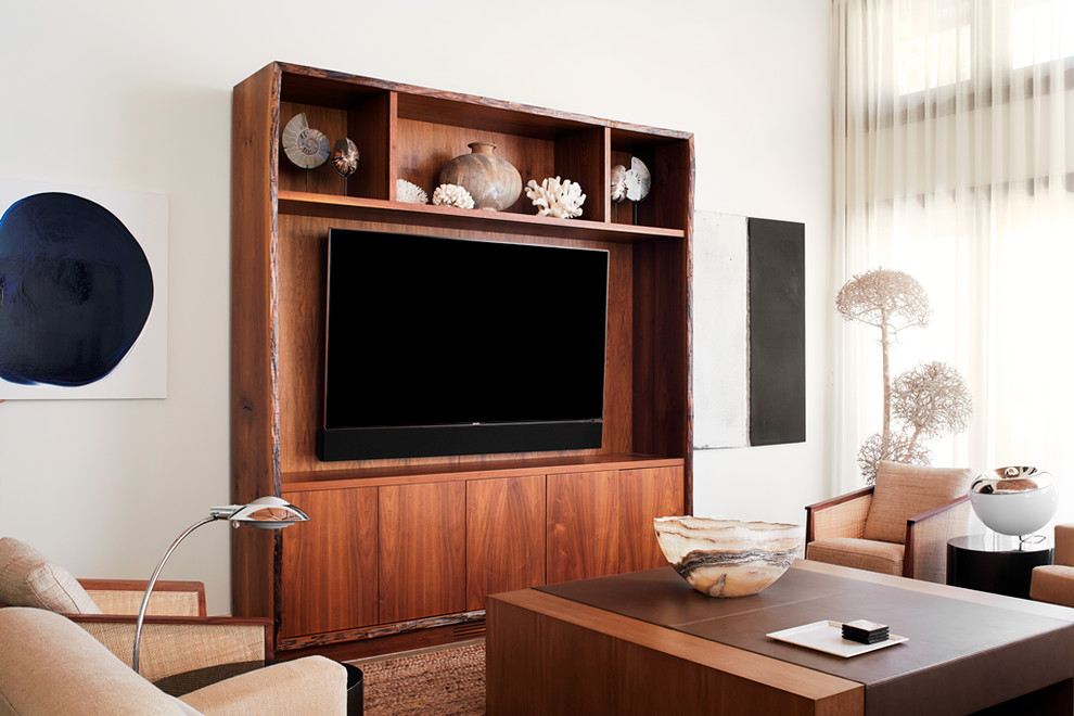 This is an example of an expansive tropical open concept living room in Other with white walls and a wall-mounted tv.