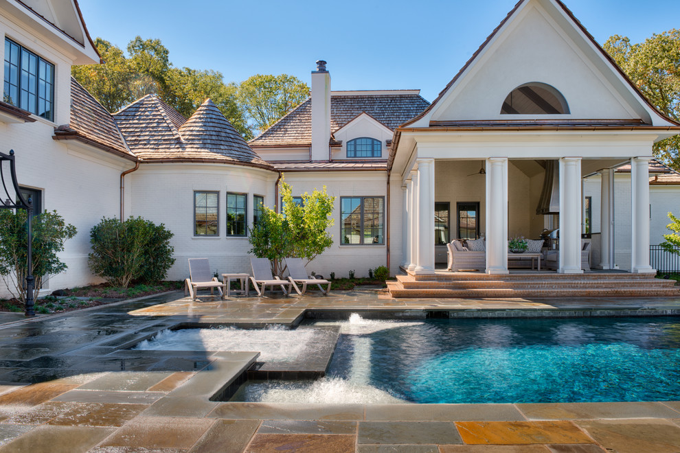 Pool house - mid-sized transitional indoor stone and rectangular pool house idea