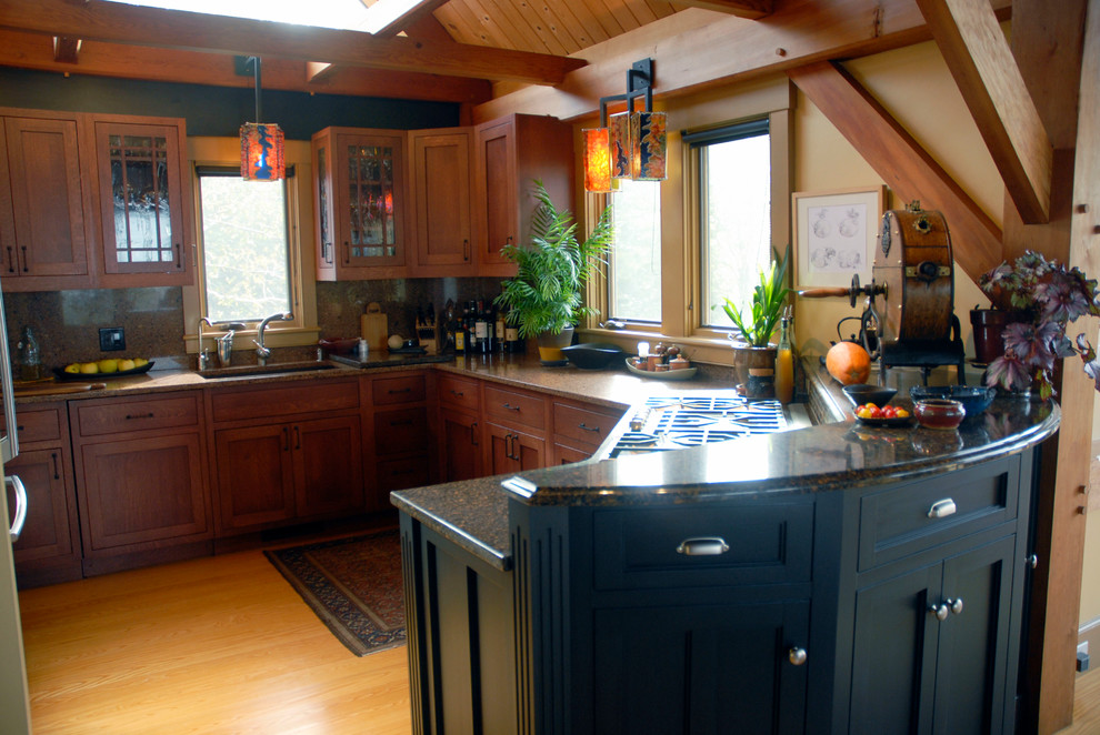 Elegant u-shaped kitchen photo in Burlington with an undermount sink and recessed-panel cabinets