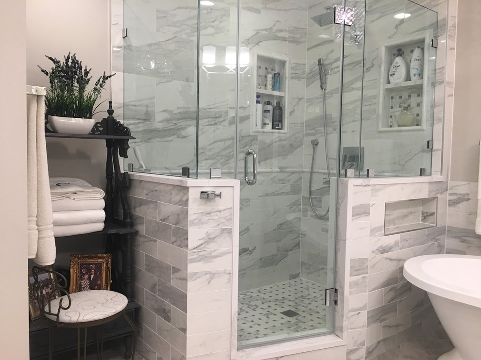 Inspiration for a mid-sized transitional master bathroom in DC Metro with recessed-panel cabinets, white cabinets, a freestanding tub, a corner shower, gray tile, marble, grey walls, marble floors, granite benchtops, grey floor, a hinged shower door and white benchtops.