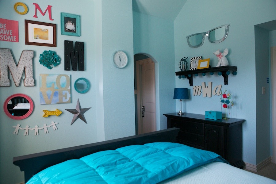 This is an example of a mid-sized eclectic bedroom in Dallas with blue walls and carpet.