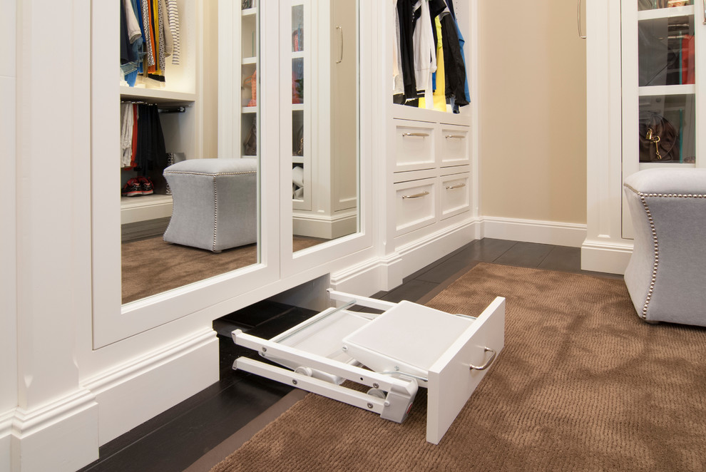 Mid-sized traditional gender-neutral dressing room in San Francisco with recessed-panel cabinets, white cabinets and dark hardwood floors.