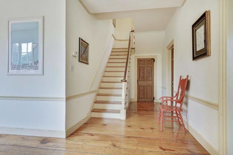 Mid-sized traditional wood straight staircase in New York with painted wood risers and wood railing.