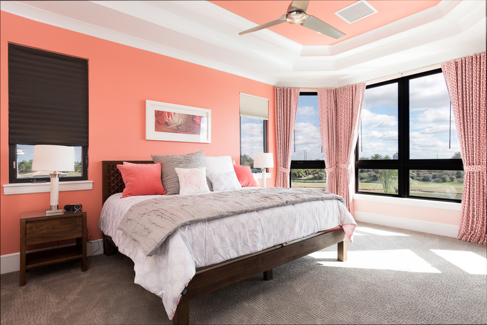 Large transitional guest bedroom in Orlando with orange walls, carpet and no fireplace.