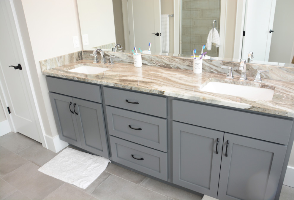 Design ideas for a mid-sized beach style master bathroom in Baltimore with shaker cabinets, grey cabinets, a freestanding tub, beige walls, an undermount sink, granite benchtops, grey floor, beige benchtops, a double vanity and a freestanding vanity.