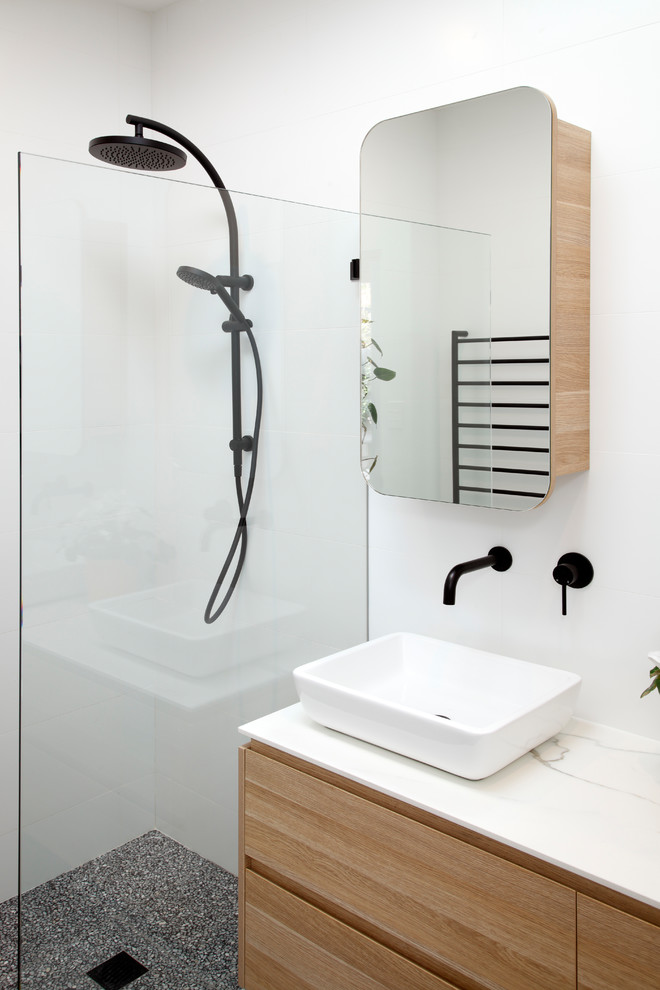 This is an example of a small modern 3/4 bathroom in Sydney with flat-panel cabinets, light wood cabinets, a double shower, white tile, porcelain tile, concrete floors, a vessel sink, solid surface benchtops, purple floor, an open shower and white benchtops.