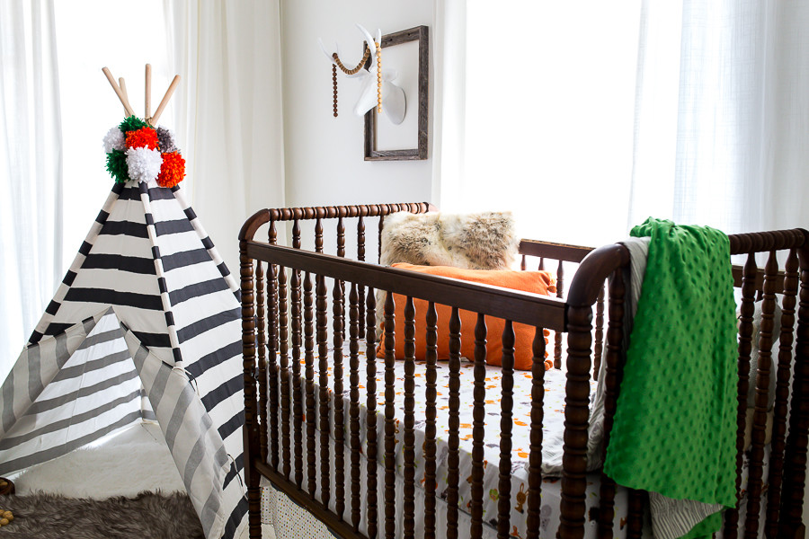 Inspiration for a mid-sized eclectic gender-neutral nursery in Atlanta with white walls and painted wood floors.