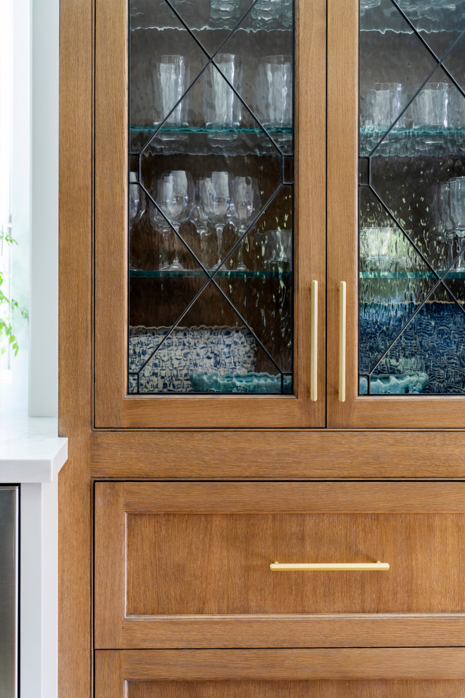 Home bar - traditional home bar idea in San Francisco with recessed-panel cabinets