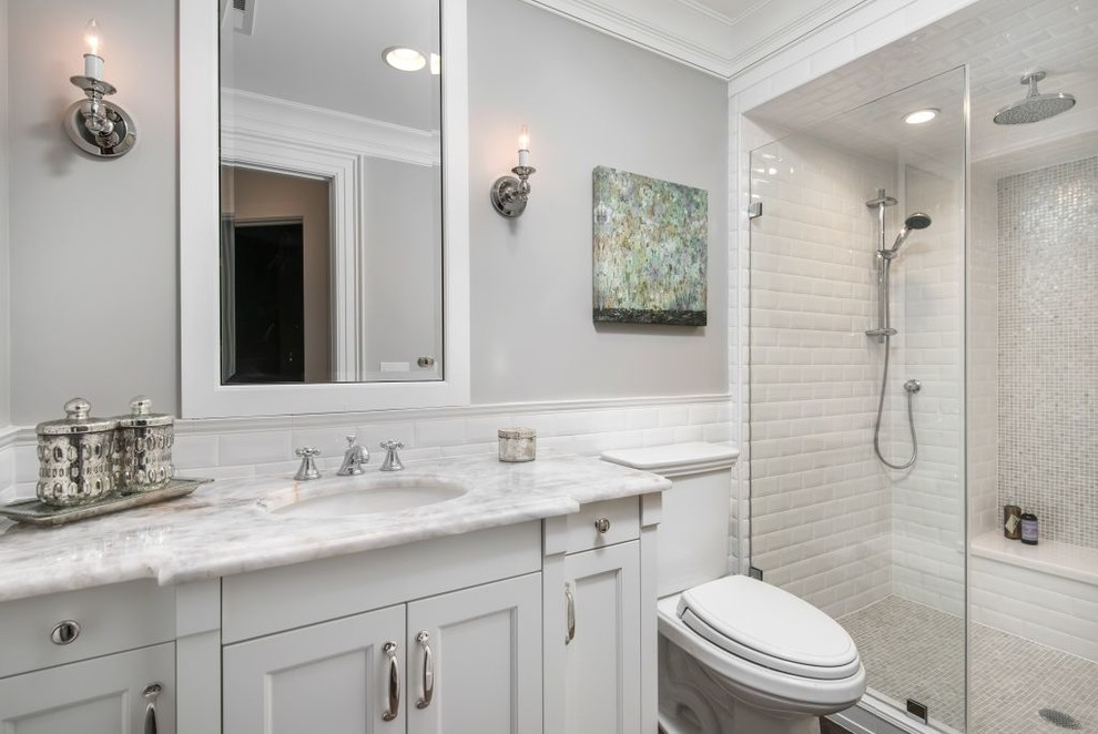 Mid-sized transitional bathroom in Chicago with furniture-like cabinets, white cabinets, a two-piece toilet, white tile, ceramic tile and grey walls.