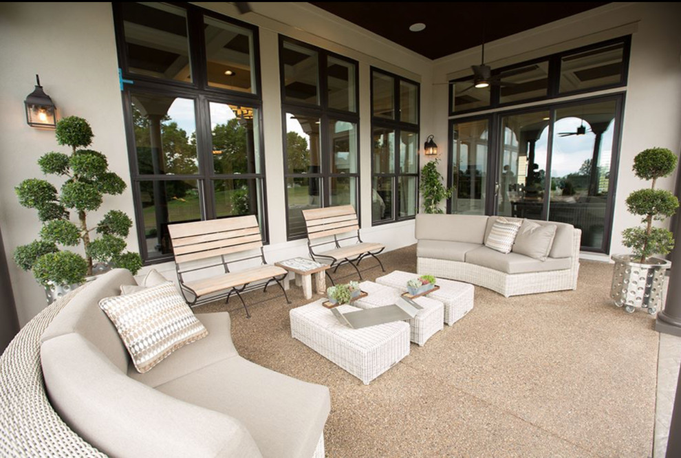 Inspiration for a large traditional backyard verandah in Columbus with tile and a roof extension.