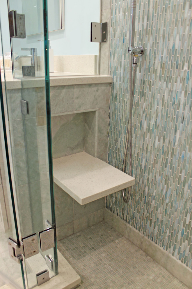 Inspiration for a mid-sized traditional master bathroom in Boston with recessed-panel cabinets, beige cabinets, an undermount tub, an alcove shower, a wall-mount toilet, green tile, glass tile, blue walls, marble floors, an undermount sink, engineered quartz benchtops, green floor, a hinged shower door and white benchtops.