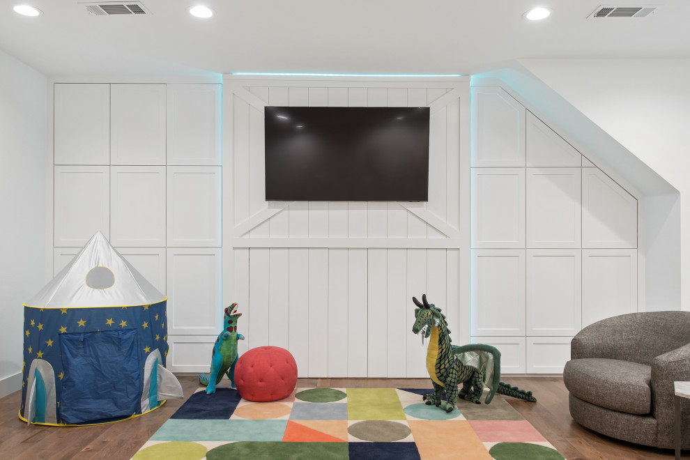 This is an example of a mid-sized transitional enclosed family room in Dallas with a game room, white walls, medium hardwood floors and a built-in media wall.