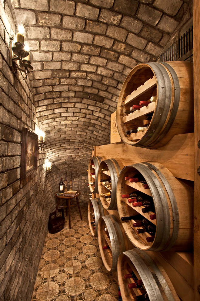 This is an example of a small mediterranean wine cellar in Orange County with storage racks.