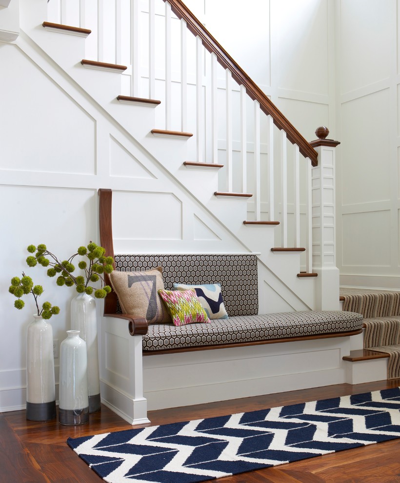 Photo of a beach style foyer in Boston with white walls and light hardwood floors.