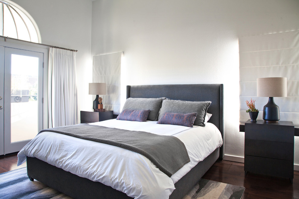 Photo of a large contemporary master bedroom in Los Angeles with white walls, dark hardwood floors and no fireplace.