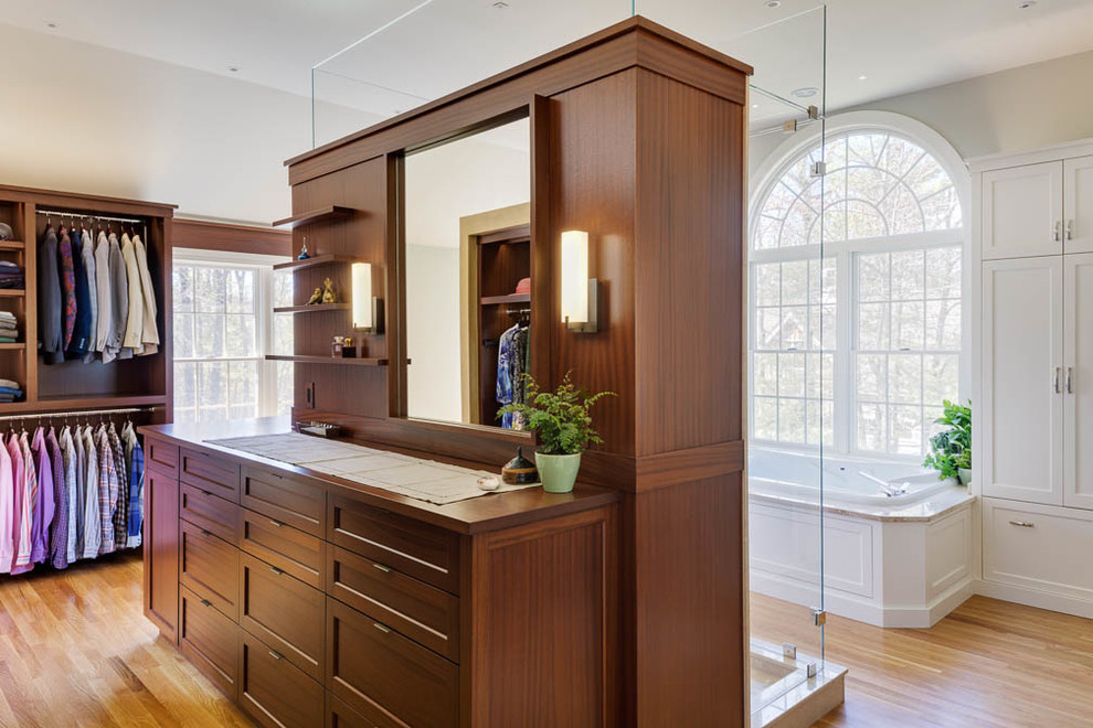 Large transitional dressing room in Boston with flat-panel cabinets, dark wood cabinets and medium hardwood floors.
