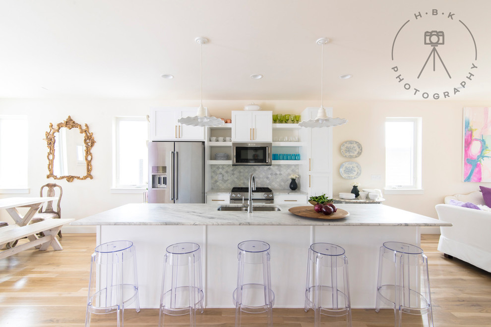 Inspiration for a small transitional single-wall light wood floor and beige floor open concept kitchen remodel with a double-bowl sink, shaker cabinets, white cabinets, marble countertops, gray backsplash, stainless steel appliances, an island and white countertops