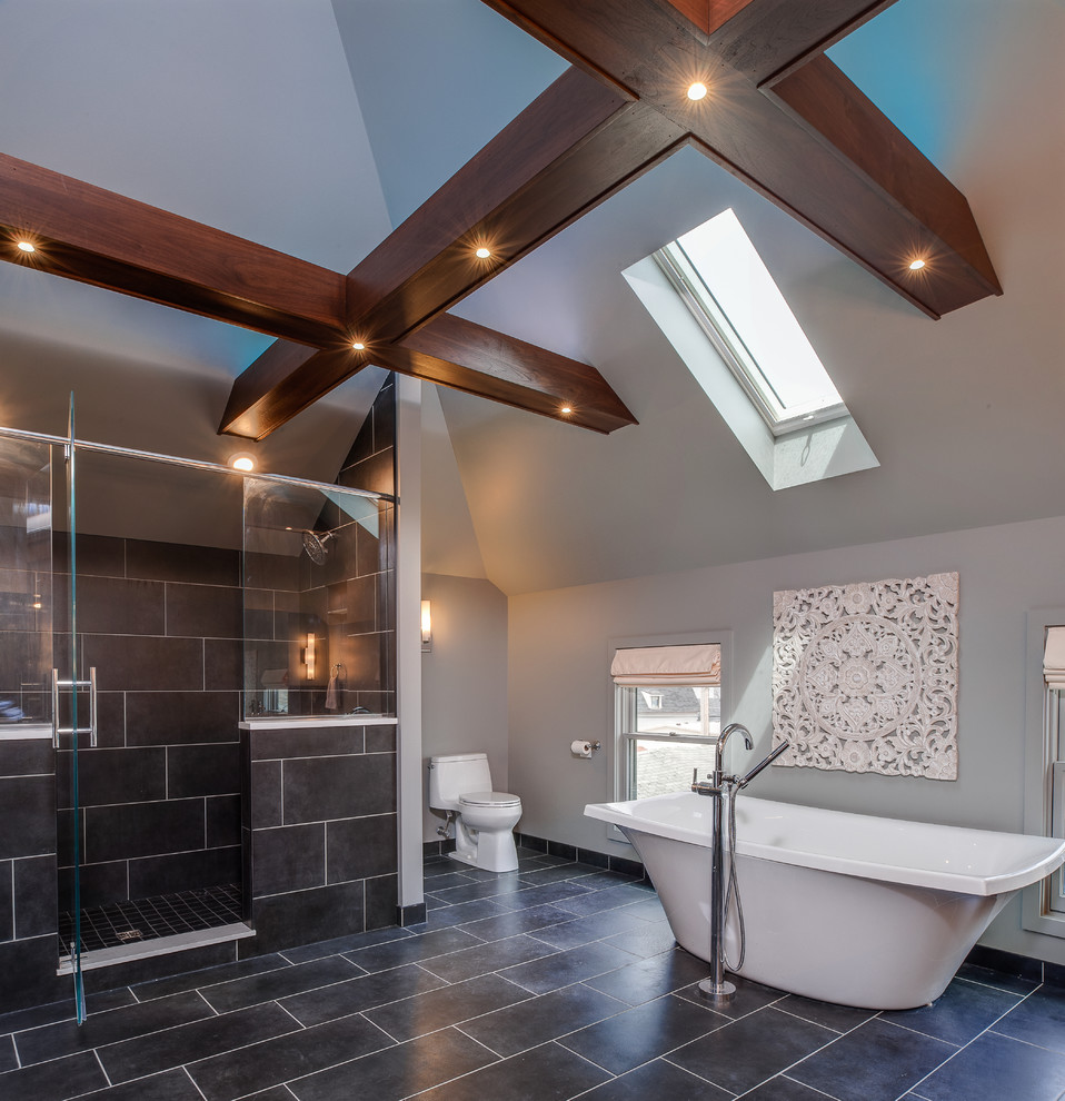 This is an example of an expansive transitional master bathroom in Other with an undermount sink, flat-panel cabinets, dark wood cabinets, engineered quartz benchtops, a freestanding tub, a double shower, a one-piece toilet, multi-coloured tile, ceramic tile, grey walls and ceramic floors.