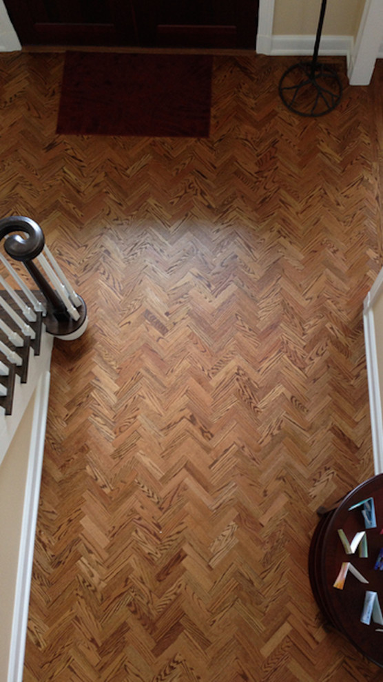 Inspiration for a medium tone wood floor foyer remodel in Miami with beige walls
