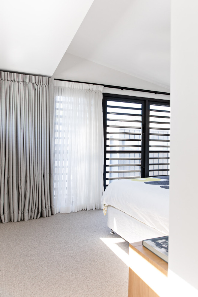 Mid-sized contemporary master bedroom in Sydney with white walls, carpet and beige floor.
