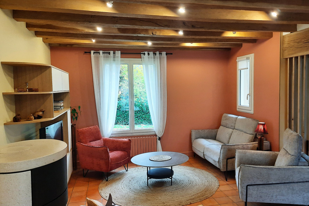 Inspiration pour un salon rustique fermé avec une salle de réception, un mur orange, un poêle à bois, un téléviseur indépendant et un sol orange.