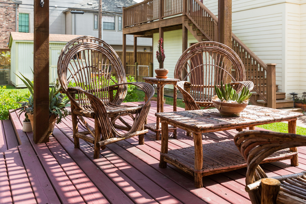 Small eclectic backyard deck in Houston with a pergola.