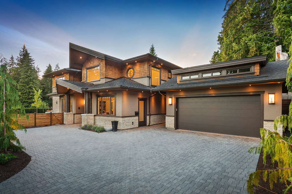 Design ideas for an expansive arts and crafts two-storey brown house exterior in Vancouver with mixed siding, a gable roof and a shingle roof.