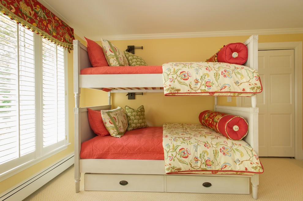 Design ideas for a traditional gender-neutral kids' bedroom for kids 4-10 years old in Boston with yellow walls and carpet.