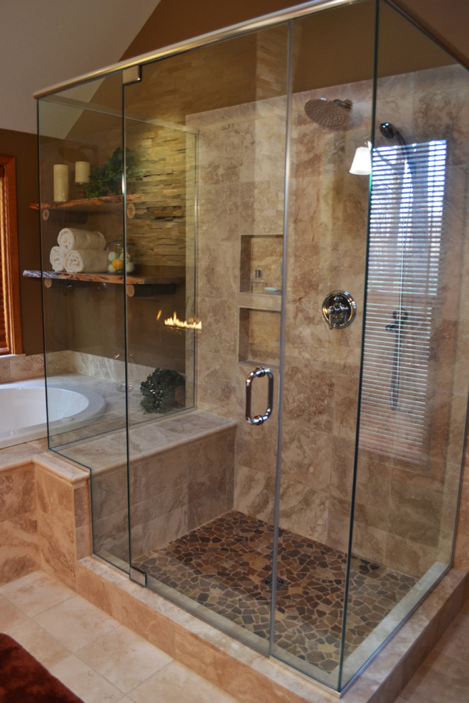 Mid-sized country master bathroom in Philadelphia with shaker cabinets, medium wood cabinets, a drop-in tub, an open shower, a two-piece toilet, brown tile, limestone, multi-coloured walls, travertine floors, an undermount sink, granite benchtops, beige floor and a hinged shower door.