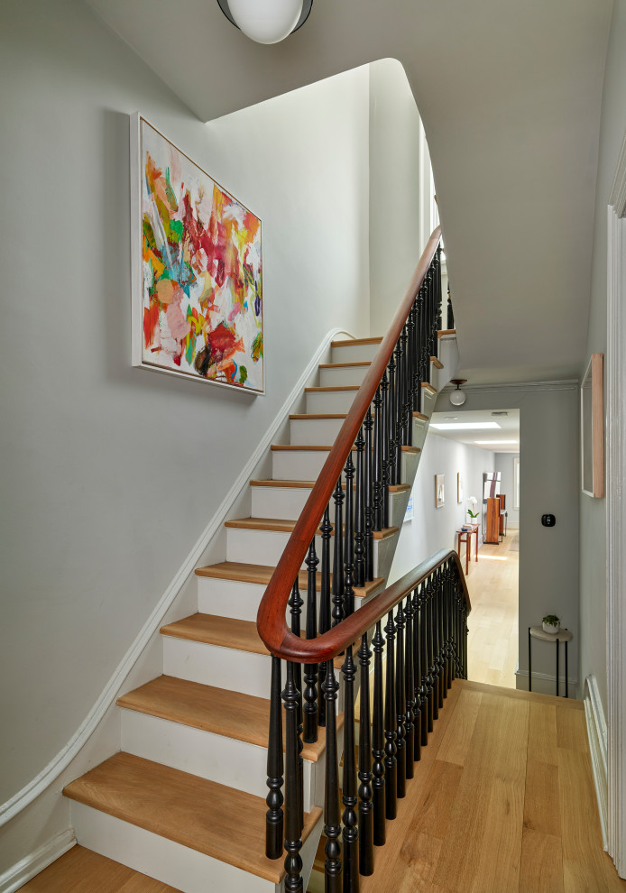 Inspiration for a mid-sized transitional wood straight staircase in Philadelphia with painted wood risers and wood railing.