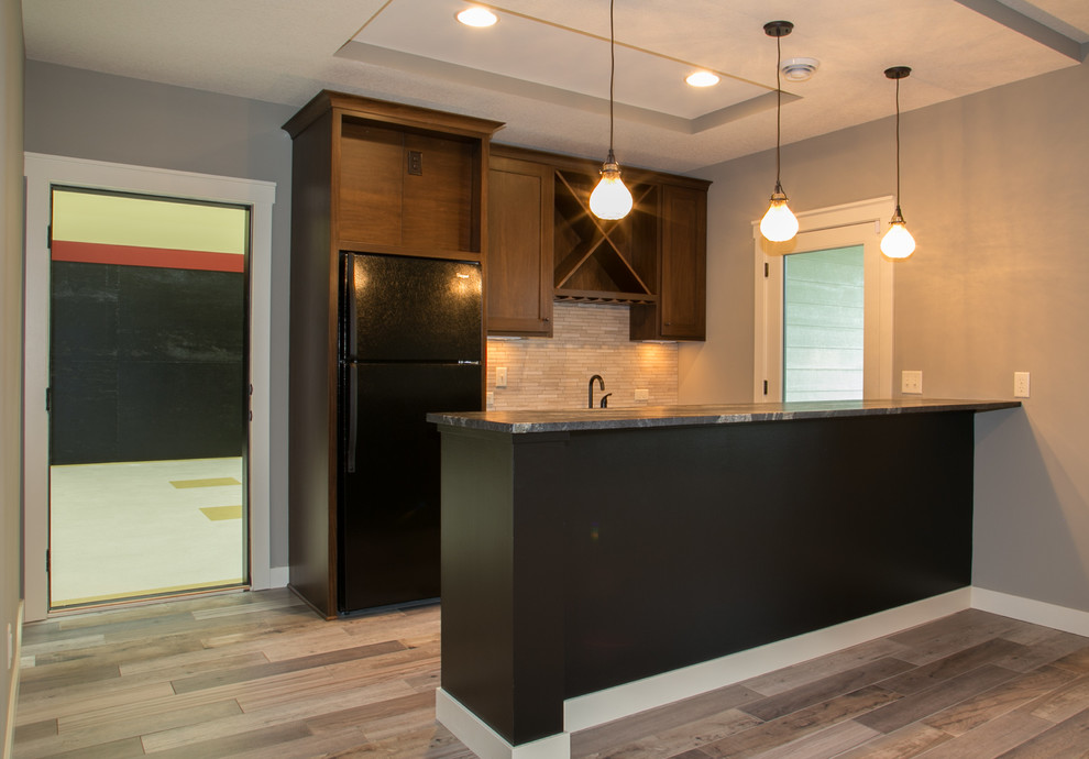 Inspiration for a transitional walk-out porcelain tile basement remodel in Minneapolis with gray walls