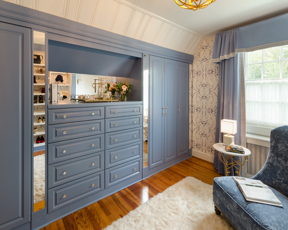 Transitional walk-in wardrobe in Richmond with raised-panel cabinets and blue cabinets.